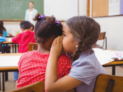 cute pupils whispering in class